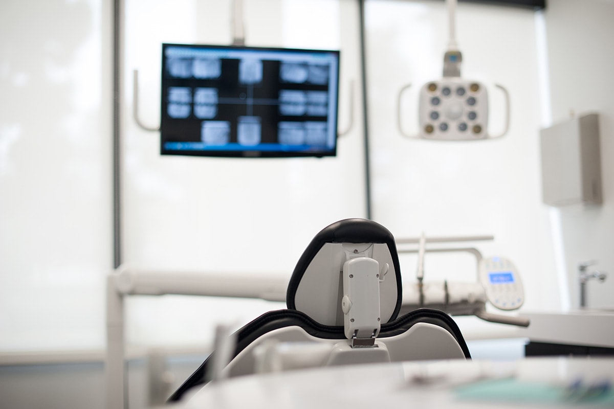 Dental chair with overhead monitor