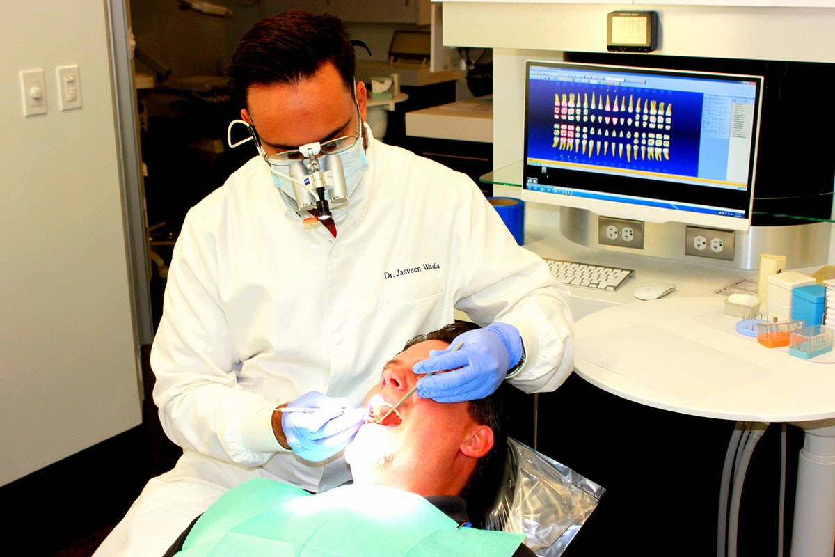 Friendly dentist with patient at Wadia Dental Group